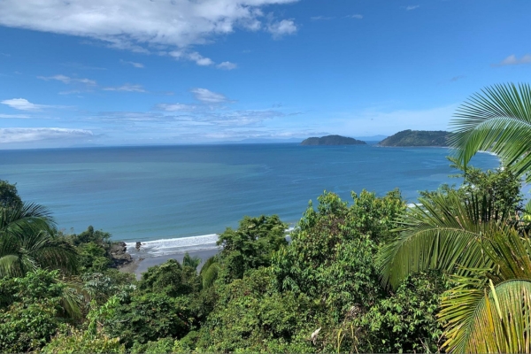 Aerial view of Costa Rica's coastline with turquoise waters, tropical forest, and distant islands